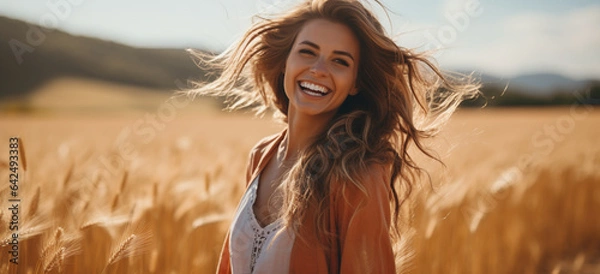 Fototapeta portrait of a woman in a wheat field enjoying sunny day
