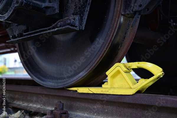 Obraz Yellow rail chock on a railcar.