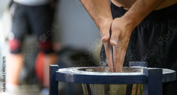 Obraz Chalking Hands at a Weightlifting Event