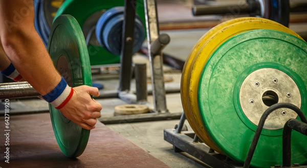 Fototapeta Weightlifter Loading a Barbell