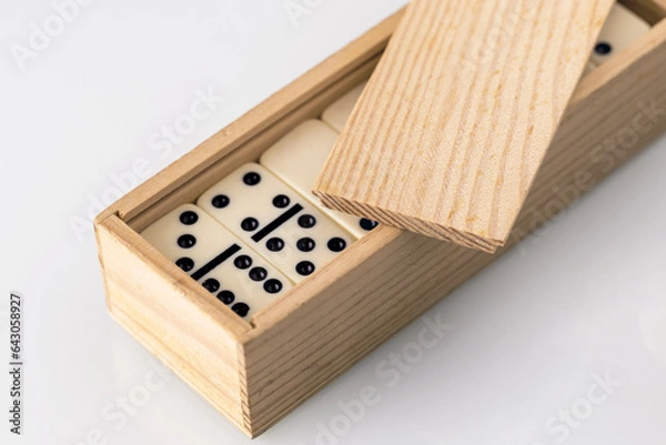 Fototapeta domino tiles stacked in a wooden box
