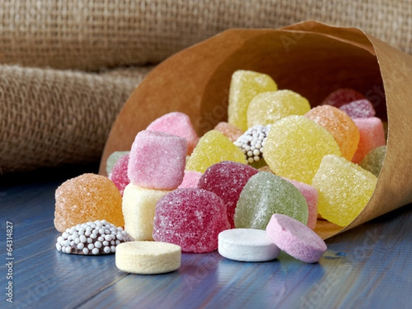 Obraz Paper bag filled with sugar candy sweets