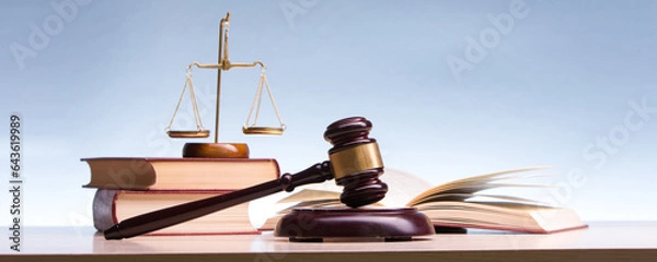 Fototapeta Legal Law and Justice concept - Open law book with a wooden judges gavel on table in a courtroom or law enforcement office. Copy space for text.