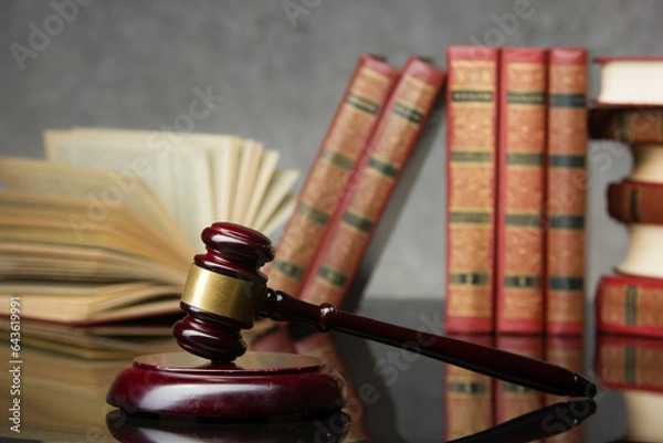 Fototapeta Legal Law and Justice concept - Open law book with a wooden judges gavel on table in a courtroom or law enforcement office. Copy space for text.