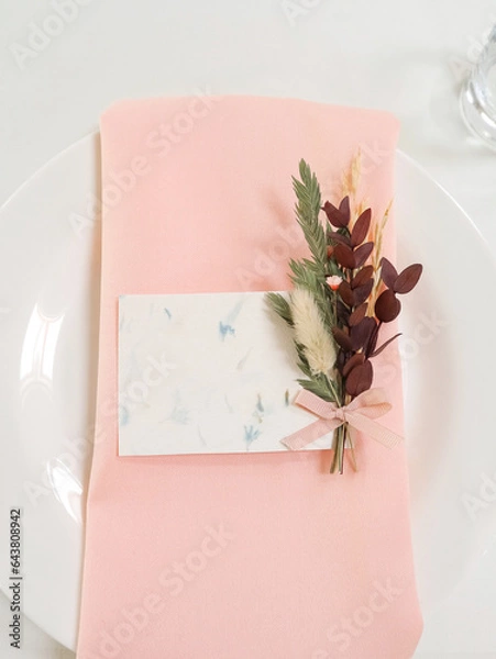 Fototapeta Setting the table for a wedding. Flowers, white tablecloth, dishes. Decor. Holiday. Top view, space for text. High quality photo