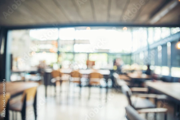 Fototapeta Blurred background cafe coffee shop restaurant in shopping mall with light bokeh business event retail store. Blurry background interior design bar table chair windows decorate indoor space display