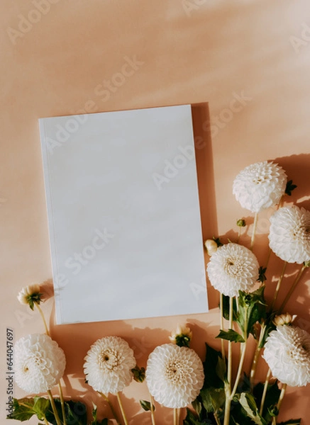 Fototapeta Empty blank white magazine cover mock up and white dahlias flowers on sunny beige background with shadows