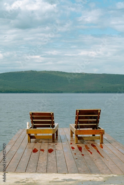 Obraz deck chairs on the pier near the lake in the mountains