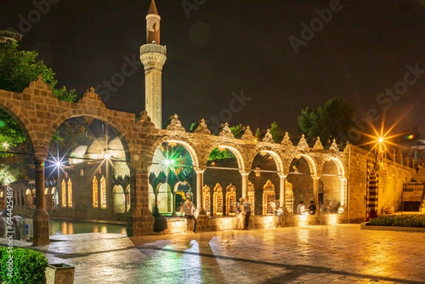 Fototapeta Sanliurfa, Turkey - June 19, 2023 : Balıklıgöl (Balık Lake) and Rizvaniye Mosque Landscape in beautiful sunset scenery in Şanlıurfa, Turkey.