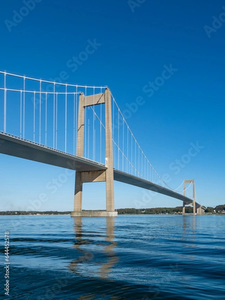 Fototapeta Den nye Lillebæltsbro stretching from Funen to Jutland in Denmark across the Lillebælt strait. Blue sky and sunny summer weather.