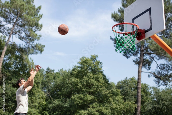 Fototapeta basketball player in action scoring