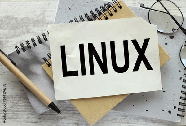 Obraz LINUX gray wooden background. gray notebook. text on the page