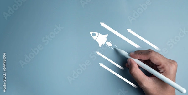 Fototapeta Business start up, start, new project, new idea concept. Magnifying glass focus on rocket launch with arrow  Leadership business strategy for goal target success.