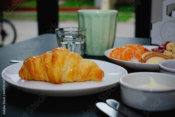 Fototapeta breakfast of croissant, coffee and fruits, healthy and nutritious breakfast