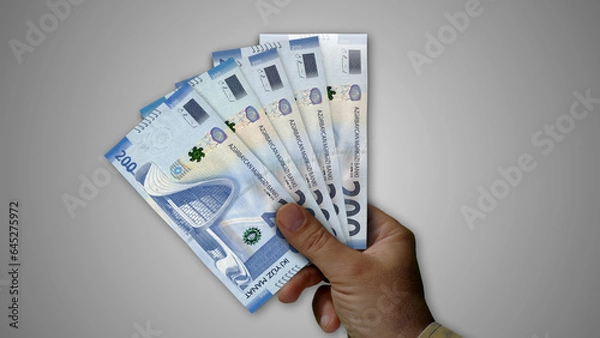 Obraz Azerbaijan Manat growing pile of money in hand concept 3d illustration