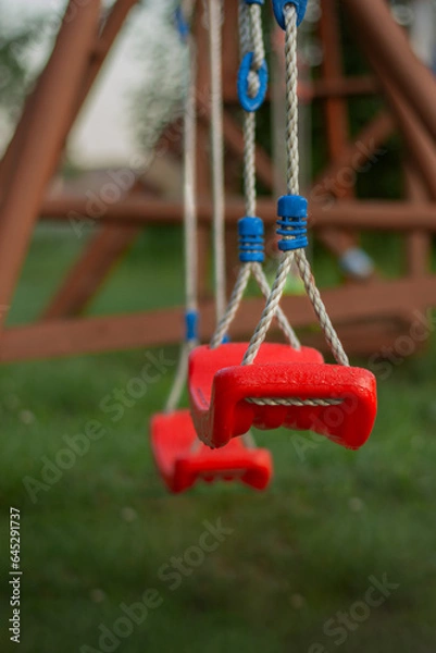 Obraz The empty red swing with ropes in the park
