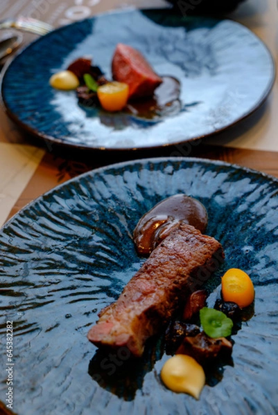 Obraz Australian Striploin Steak: Well done, and blur steak in background