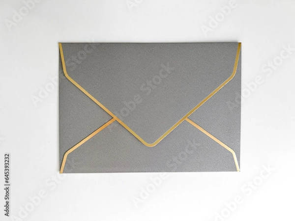 Fototapeta Silver envelope with a white liner for congratulations on a white background. Wedding invitation, for business, postcard. Flat lay, top view, copy space.