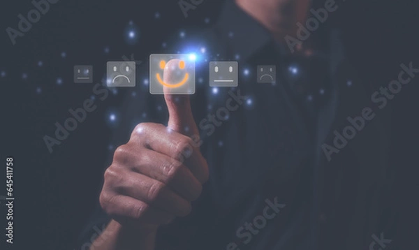 Fototapeta Customer service satisfaction survey concept.Business people or customers show satisfaction by thumb up pressing face emoticon smile in satisfaction on virtual touch screen. rating very impressed