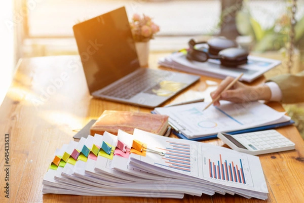 Fototapeta stack of documents on secretary desk were prepared It is legal document for real estate buyers to be used as evidence of possession. stacked papers were placed on the table awaiting examination.
