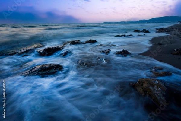 Fototapeta A seascape photographed with a long exposure technique at sunset.