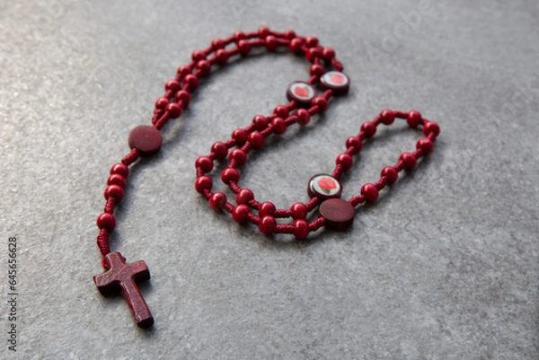 Fototapeta Red rosary on a stone background
