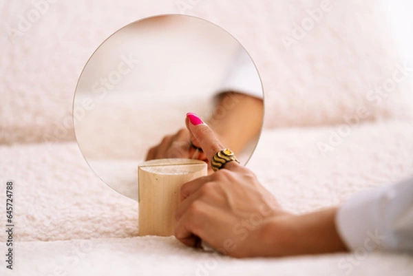 Obraz jewelry on the hand of a beautiful young girl with a reflection in the mirror