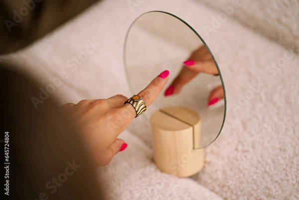 Obraz jewelry on the hand of a beautiful young girl with a reflection in the mirror