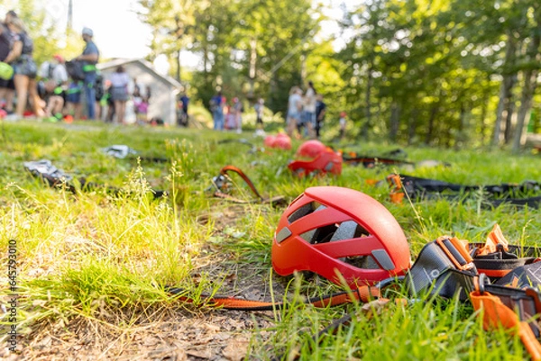 Obraz Helmets and equipment for the rope park against the background of people
