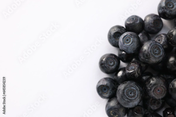 Fototapeta Pile of ripe bilberries on white background, closeup. Space for text