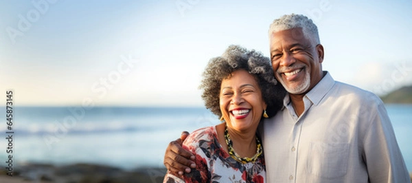 Fototapeta African senior couple on the beach with copy space