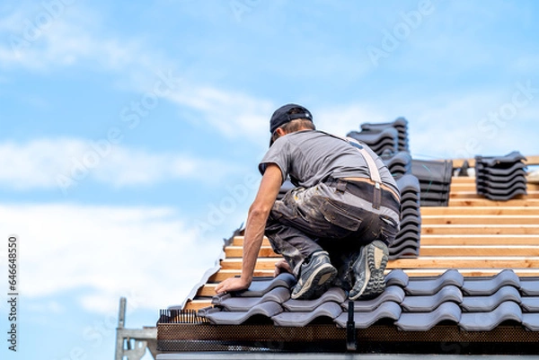 Obraz installation of the roof of a new building from ceramic tiles