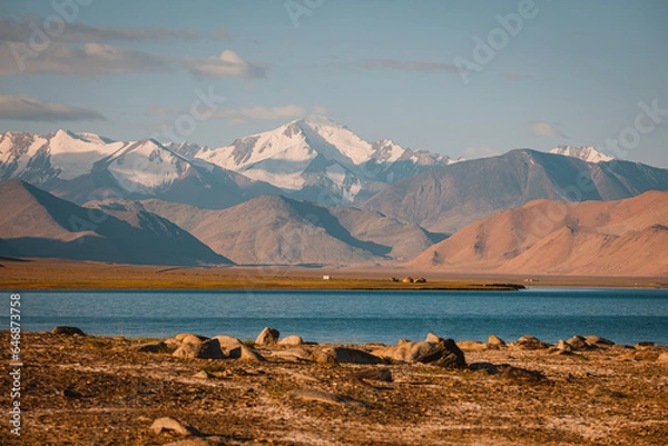 Fototapeta Incredibly beautiful lake Karakul or Karakol. Colorful colors of snowy mountains and sandy hills. Incredible berquoise water of the lake.