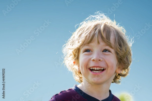 Obraz Laughing child against blue sky