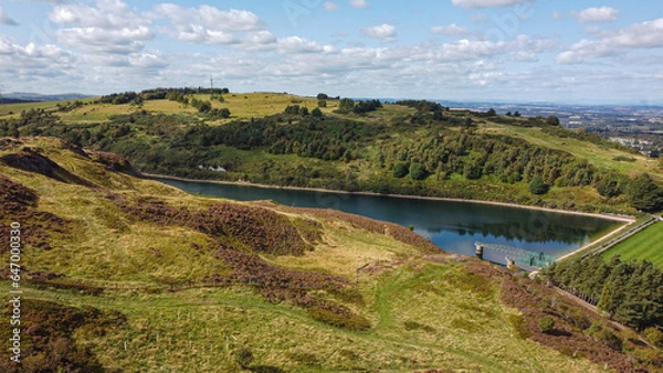 Fototapeta View of the Torduff Reservoir in Scotland. A small elongated reservoir retained by an earth embankment dam in the City of Edinburgh.