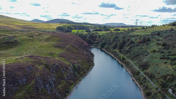 Fototapeta Nature in Scotland: Torduff Reservoir aerial view. A small elongated reservoir retained by an earth embankment dam in the City of Edinburgh.