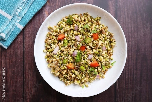 Fototapeta Sprouted moong beans. Protine rich salad. Healthy snack items. Sprouted Lentil Salad. Mixed with Onion, tomatoes, green chili and coriander. Copy space. Sprout Bhel.