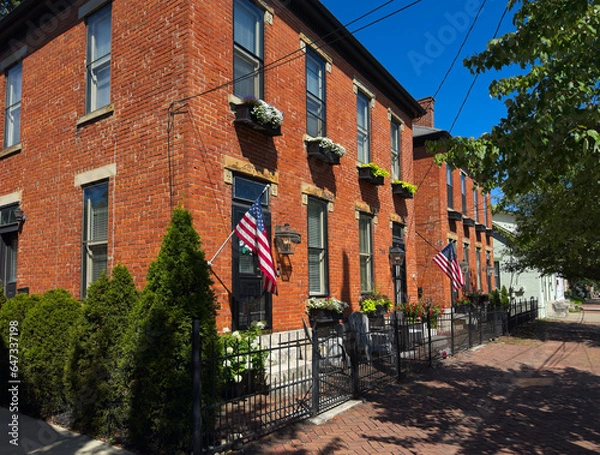 Fototapeta Old residential buildings along brick sidewalks maintain an old world charm in German Village, a uniquely preserved neighborhood of Columbus, Ohio