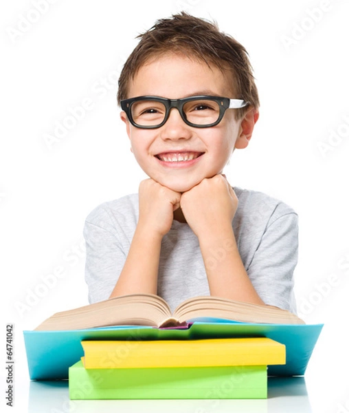Fototapeta Little boy is reading a book