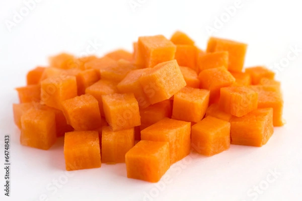 Fototapeta Carrot neatly chopped into cubes ready to be used