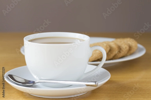 Obraz Cup of tea and biscuits on a table