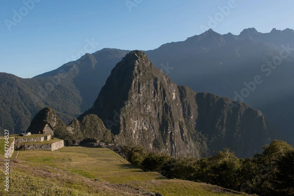 Fototapeta View of the mountains at sunrise at Machupicchu with a blue sky on a clear day, Sacred Valley, Peru. 