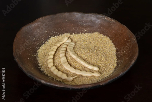 Obraz Mesquite flour and pods in rustic ceramic plate