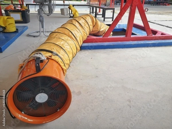 Fototapeta Yellow air ducts, fittings in ventilation systems of working in confined spaces, confined spaces are vertically pitted. It has a lot of depth.