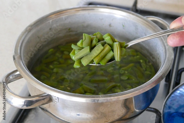 Fototapeta Chopped green beans are cooking in a pot, green beans are boiled in a pot, bean dish,