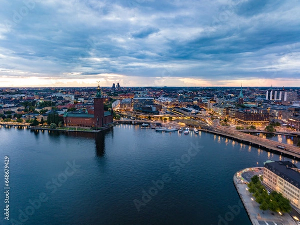 Obraz Aerial view of evening city. Transport infrastructure and popular landmarks at sunset. Famous City Hall on waterfront. Stockholm, Sweden