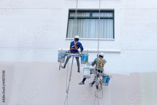 Obraz Two worker are painting the color in high buildings - Rise occup