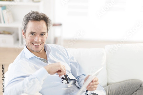 Obraz handsome man using a digital tablet