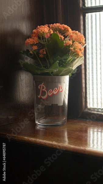Obraz flowers in a glass by window