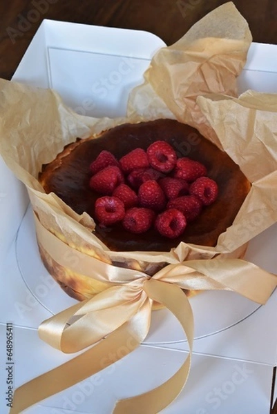 Fototapeta San Sebastian Cheesecake with raspberry in the box